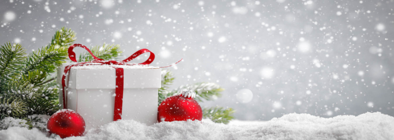 Snowy gift box and red ornament scene.