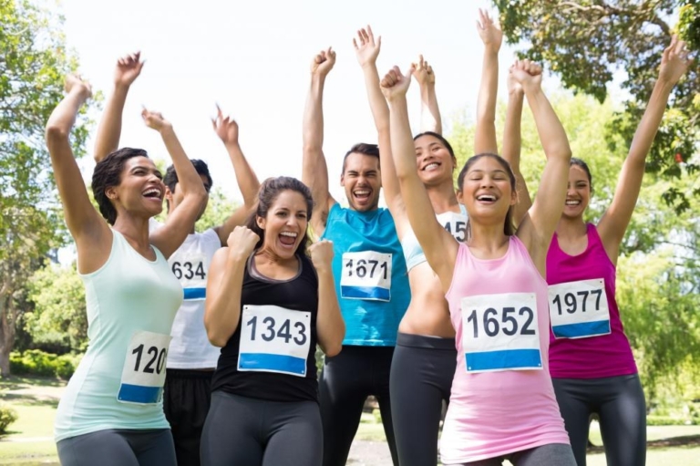 Runners celebrating together after finishing a race.